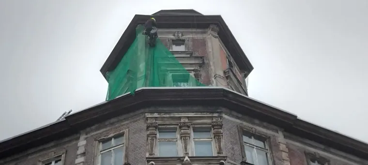 Górna część budynku osłonięta siatką